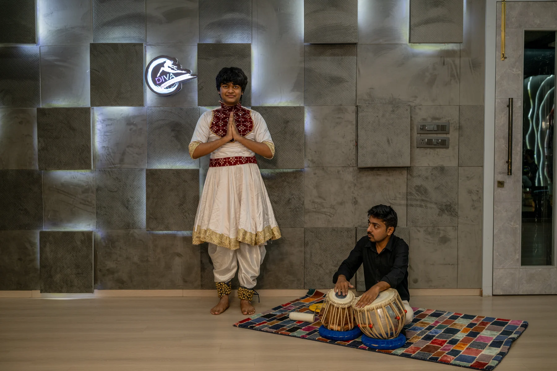 Kathak dancer greeting the audience beside a tabla player