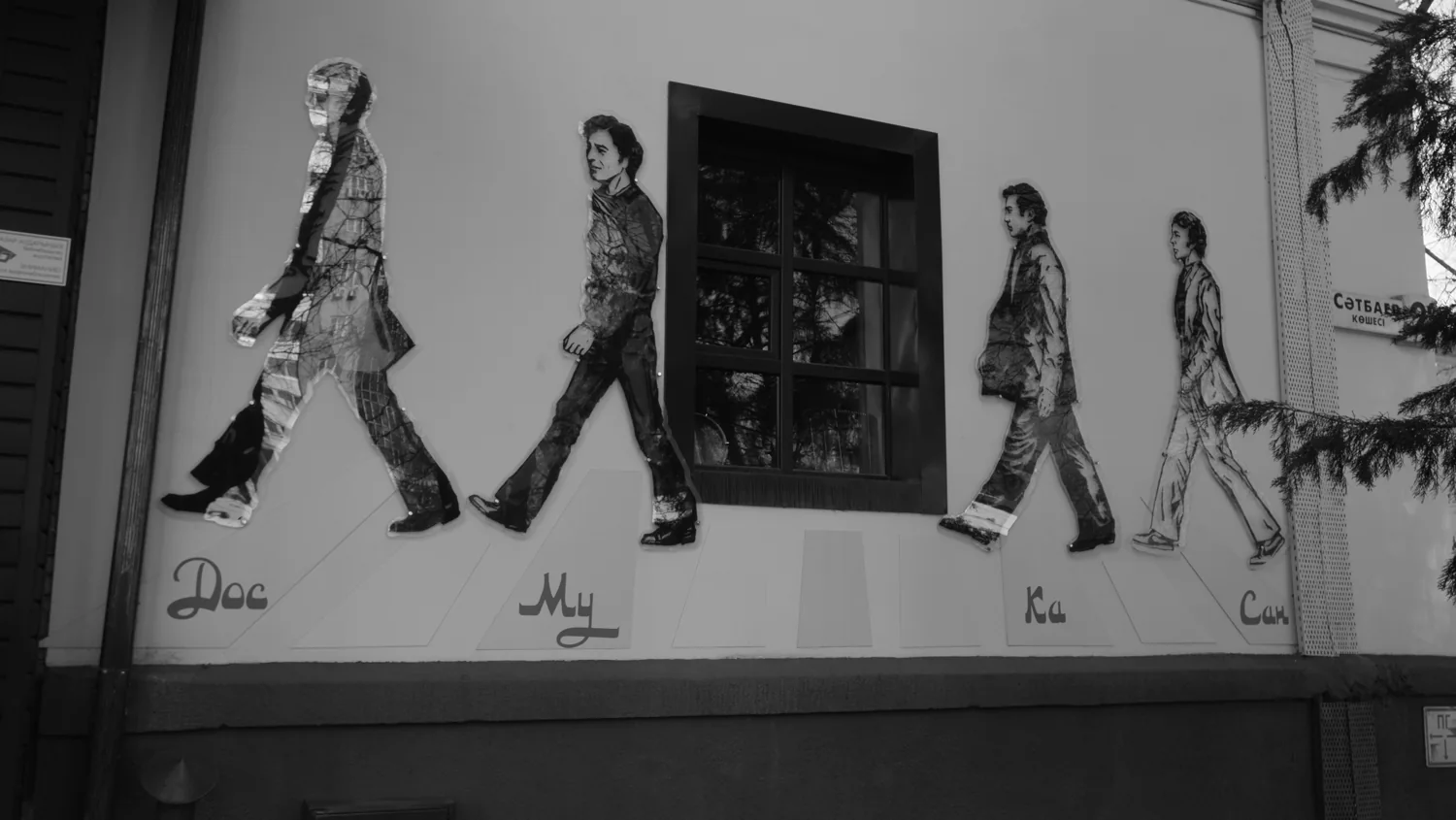 A black-and-white photograph of a Beatles mural