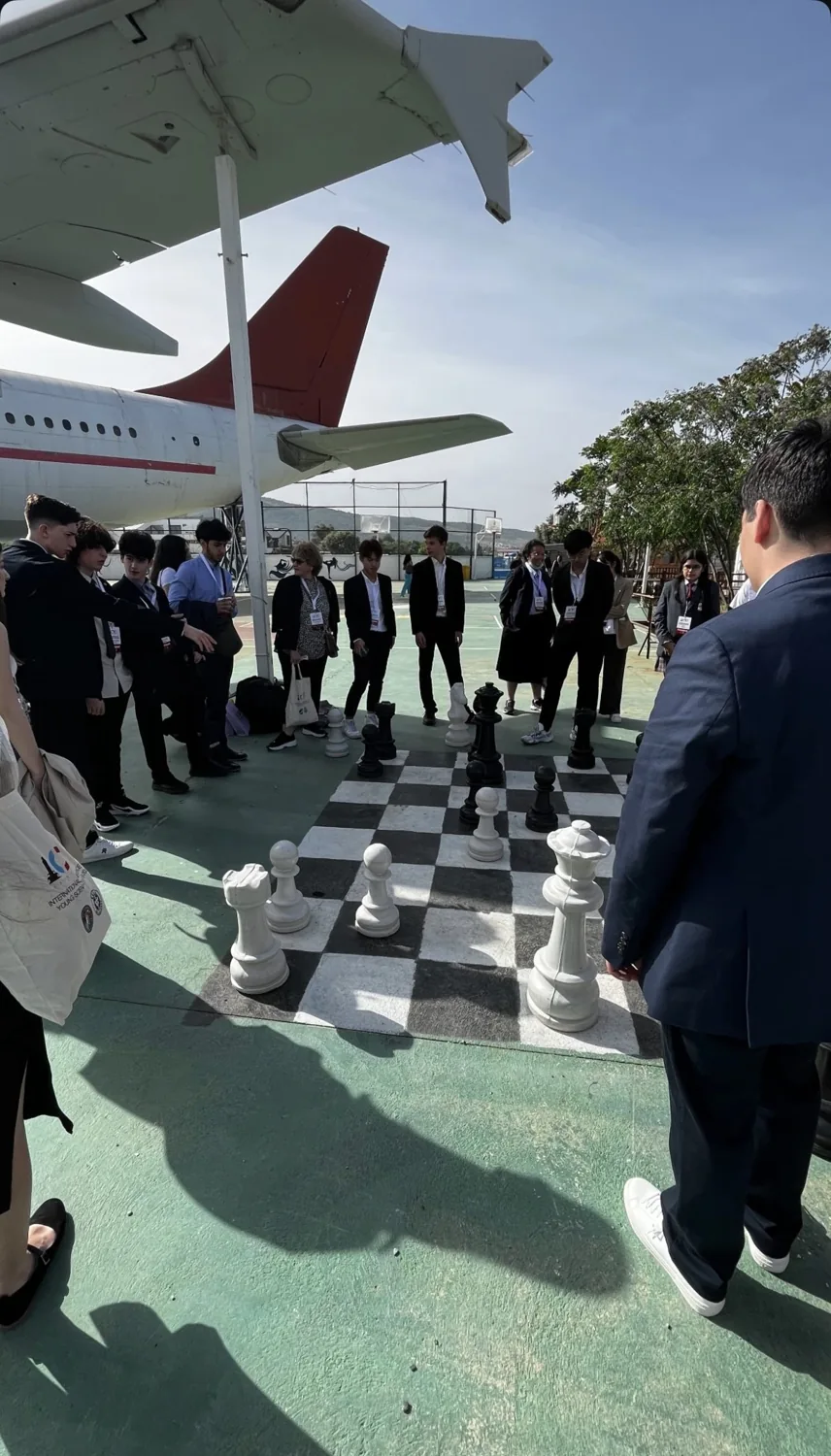 A game of giant chess beneath an aeroplane
