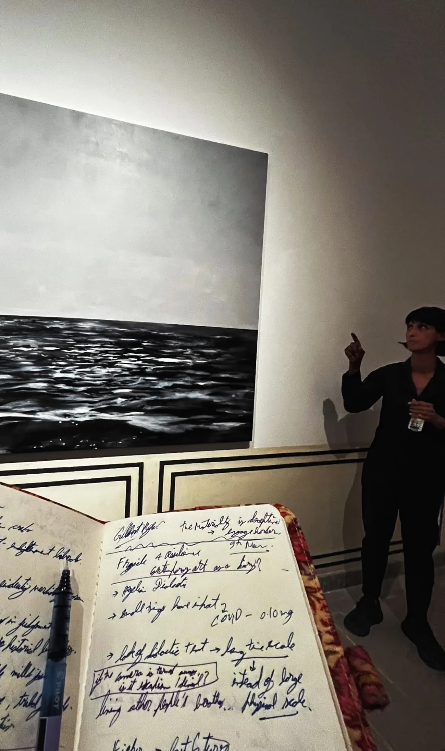 Taking notes during a discussion in an art gallery