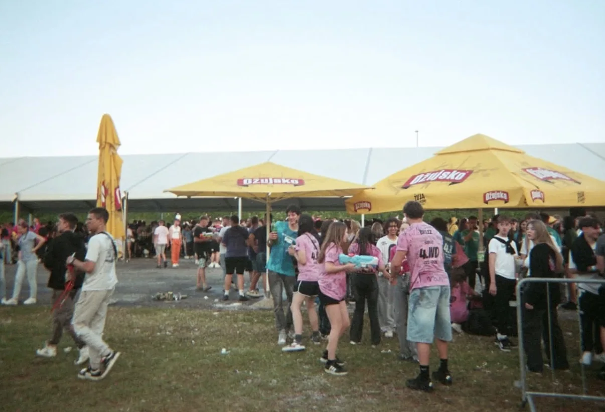 An outdoor gathering beneath yellow parasols