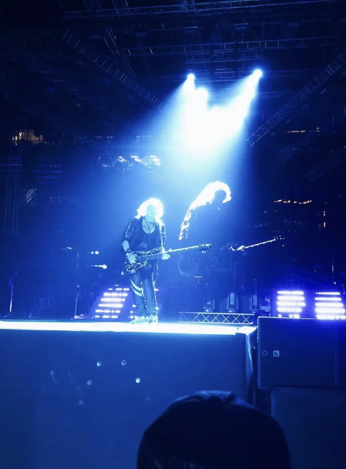 Musicians performing under blue stage lights